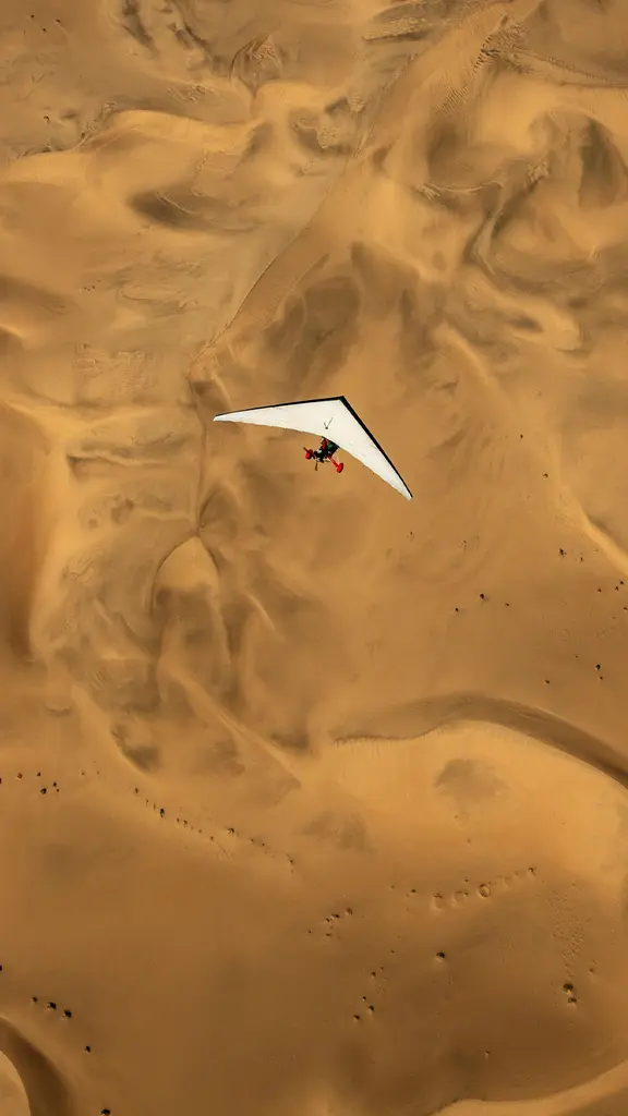 An ultralight aircraft flying over the sands of Namibia